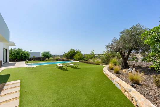 Modern home exterior with pool and landscaped garden
