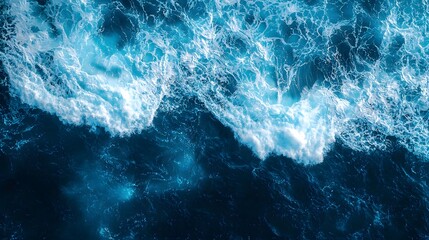 Fototapeta premium Dynamic waves crashing with foam in vibrant blue ocean waters.