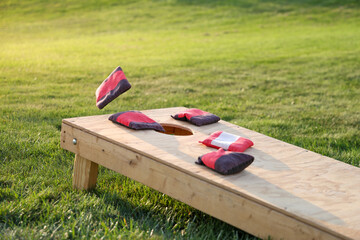 backyard game of cornhole, bags on the board 