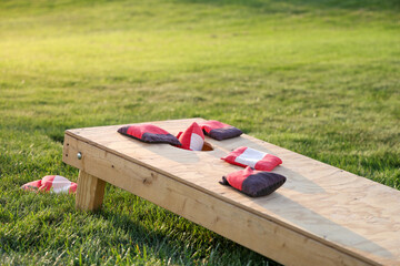 Red cornhole bag entering goal hole