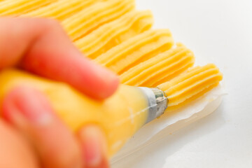 Raw churros dough spuit on flower stainless steel. Included hand for commercial use and space for text