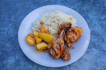 oven-fried chicken legs, french fries and rice pilaf.