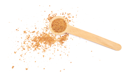 Pile of coconut palm sugar in wooden spoon isolated on white, top view