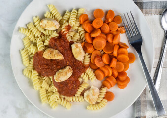 rotini top with  sauce and  chicken