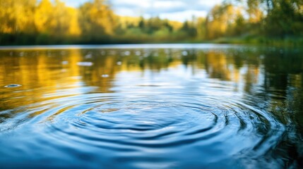 Fototapeta premium Detailed view of a serene lake with rippling waves reflecting the surrounding trees and sky --