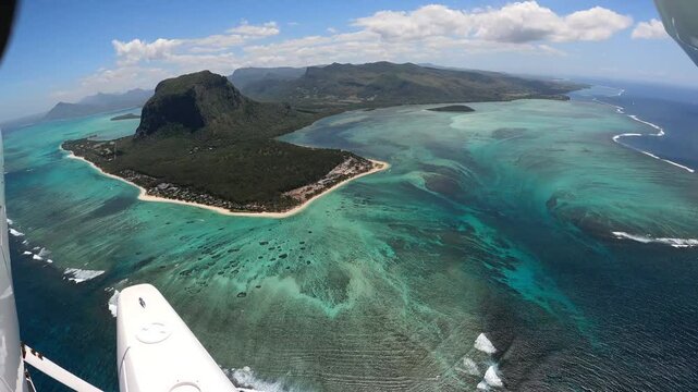 Underwater waterfall illusion view from the plane on the island of Mauritius