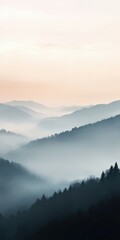 Fototapeta premium Misty mountain landscape at dawn with a soft pastel sky in the distance