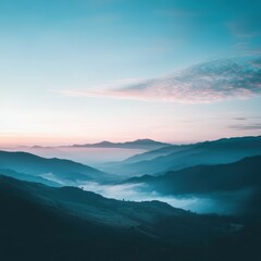 Dawn breaks over misty valleys and mountains in tranquil blue hues