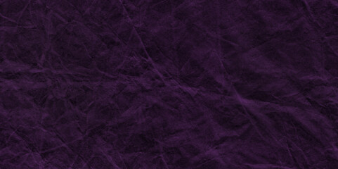 Purple crumpled paper texture in low light background. Silk cloth texture. Fabric pattern. crumpled kraft paper. A crumpled sheet of dark pink and purple paper abstract background. old paper texture. 