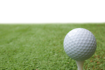 How about: Golf ball on tee on green grass, with a clear blue sky in the background