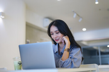 Beautiful girl waves hands at laptop camera says hello to coworkers connects to work meeting online