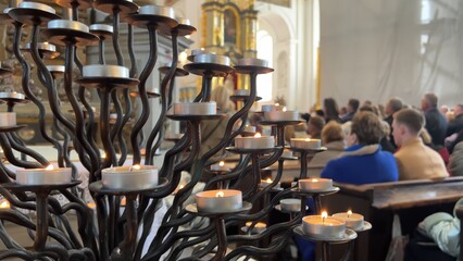 Burning candles in a Catholic church during the Divine Service.