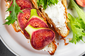 sandwich fig croissant, cream cheese fresh meal food snack on the table copy space food background rustic top view vegetarian vegan food