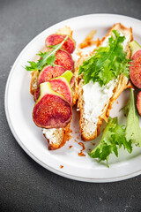 sandwich fig croissant, cream cheese fresh meal food snack on the table copy space food background rustic top view vegetarian vegan food