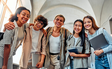 Portrait of smiling multicultural students looking at camera. Friends and student life.