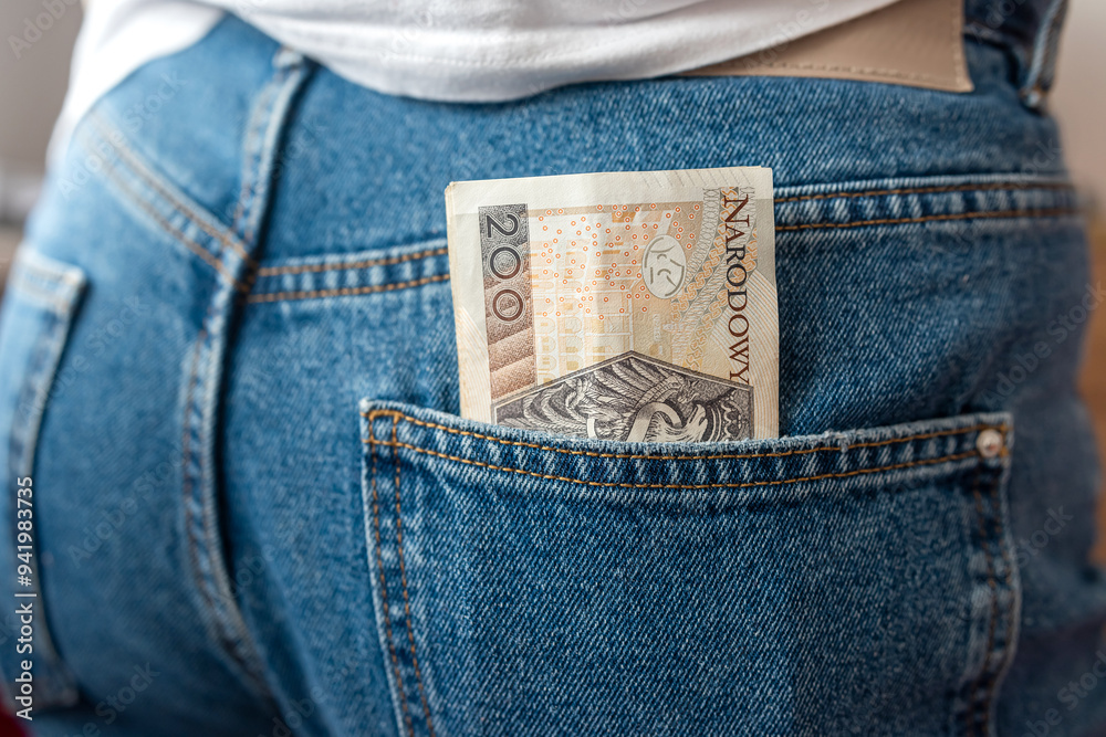 Poster  Lots of Polish banknotes of the back pocket of denim pants. Money in a Jeans Pocket