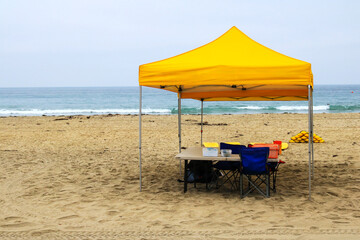 Mission beach with lifeguard yellow tent and swimming boards in the morning, San Diego, California