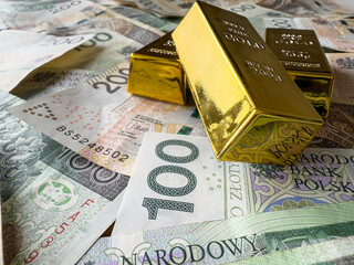 Gold bars on polish money zloty pln zl as financial saving concept