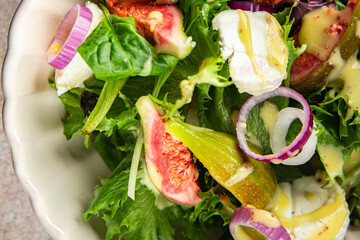 salad fig fresh green lettuce, figs, soft cheese meal food snack on the table copy space food background rustic top view vegetarian vegan food