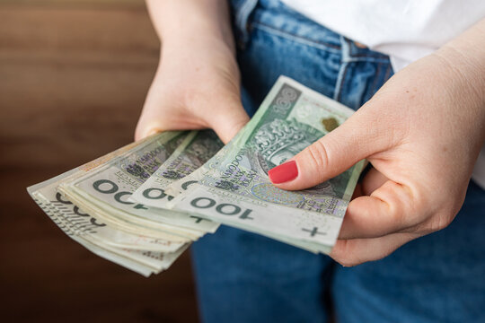  woman counts the polish zloty pln money, saving or rich concept