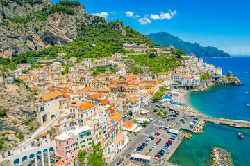 Naklejka premium Amalfi on Amalfi Coast, Italy. Aerial photo of famous city Amalfi located on Amalfi Coast with blue sea water and beautiful colorful houses on the cliff