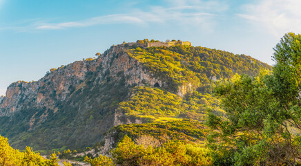 Voidokilia beach, lagoon with beaches in mediterranean, Ionian Sea, Pylos town , Greece. Navarino Castle on hill.