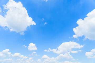 Bright blue sky background with puffy white clouds