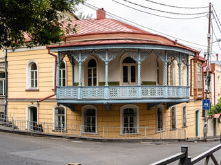 old city house with openwork wooden balcony