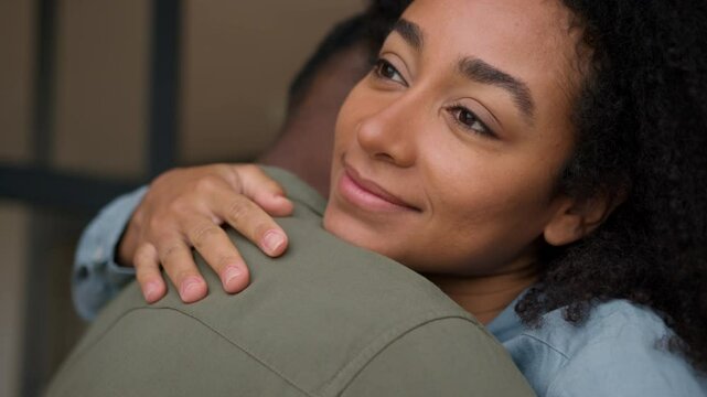 Love couple hugging indoors African American woman girl female girlfriend wife embrace cuddle gentle hug man husband male guy boyfriend loving relations family affectionate bonding romantic closeness