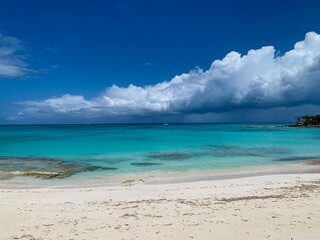 Turks and Caicos beaches feature soft, white sand blending seamlessly into crystal-clear turquoise waters. The gentle waves and endless horizon create a serene and picturesque tropical escape.
