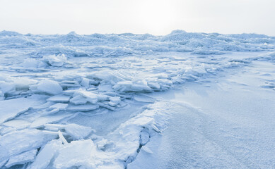 Landscape with broken ice shards laying on the coast of Baltic Sea
