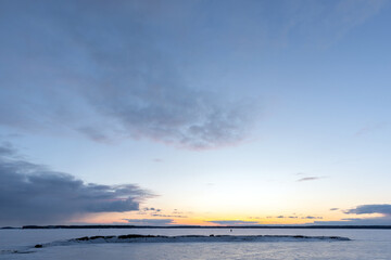 Winter landscape with sunset sky above frozen Baltic sea