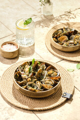 vongole with greens on a beige background