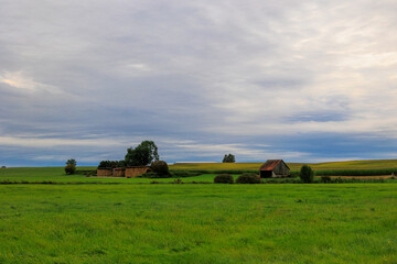 View over meadows and agricultural buildings under a cloudy sky in Merching near Augsburg