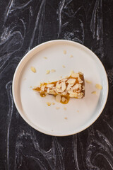 A Deliciously Crafted Slice of Almond Cake with a Beautiful Mango Glaze on an Elegant Plate