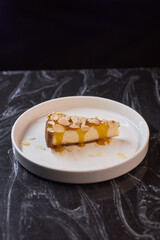 A Deliciously Crafted Slice of Almond Cake with a Beautiful Mango Glaze on an Elegant Plate