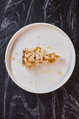 A Deliciously Crafted Slice of Almond Cake with a Beautiful Mango Glaze on an Elegant Plate