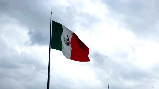 MEXICO CITY, MEXICO -AUGUST 22, 2024: Z&oacute;calo (Plaza de la Constitucion) is the common name of the main square in central Mexico City with a giant mexican flag. Slow motion steadicam footage.