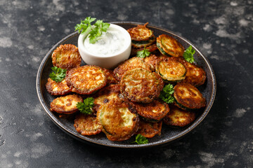Crispy fried zucchini in butter with sauce