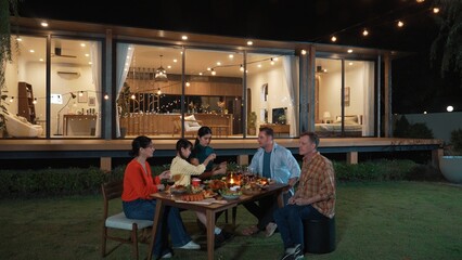 Family holding sparkler in holiday celebration dinner party. Family member enjoy play spark together. Outdoor activity spending time with toy cross generation gap strengthen family bond. Divergence.