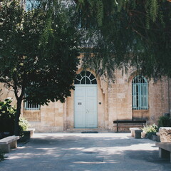 Secret garden chapel with green trees in sunny place