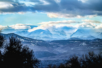 Scenic view of the Colorado Foothills in Wintertime with low lying clouds and snowcapped mountains as seen from the Highline Canal Trail in Denver.