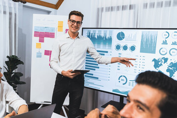 Presentation in office or meeting room with analyst team utilizing BI Fintech to analyze financial...