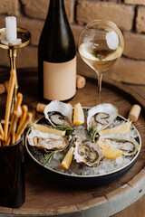 Elegant oysters on ice with lemon and white wine, perfect for gourmet dining and special occasions