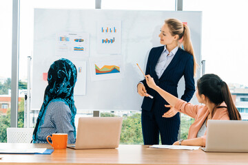 Multicultural work group. Team of businesswomen of different ethnicity, Caucasian, Asian and Arabic working together in team meeting with laptop computer at office. Multiethnic teamwork concept. uds