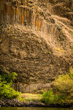 USA, Idaho. Snake River downstream of Hells Canyon, columnar basalt jointing and Permian rhyolite dikes of the Columbia River Basalt Group.