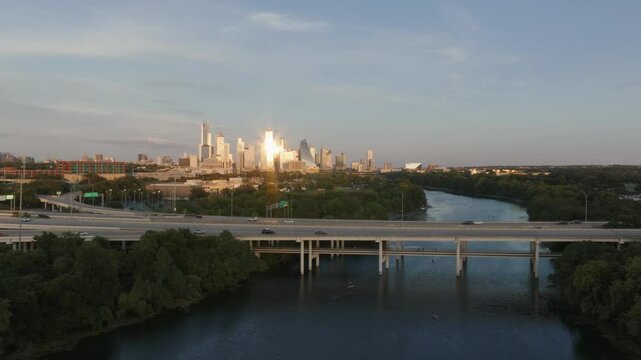 A view of mopac in front of downtown Austin during sunset.