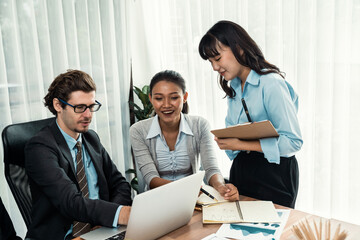 Obraz premium Diverse of business people from various ethnic group working in modern office environment. Productive and multi ethnic office workers engage in discussion for strategic business marketing. Meticulous