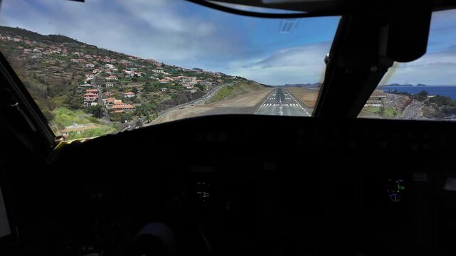 Immersive pilot real time perspective of a real time landing at dangerous Funchal Airport in Madeira Island, Portugal in a windy day with turbulence.4K 60FPS