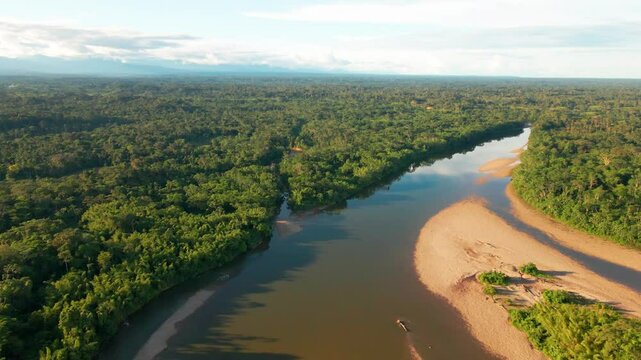 Panoramic landscape of a dirt river crossing the South american Amazonian jungle drone aerial view